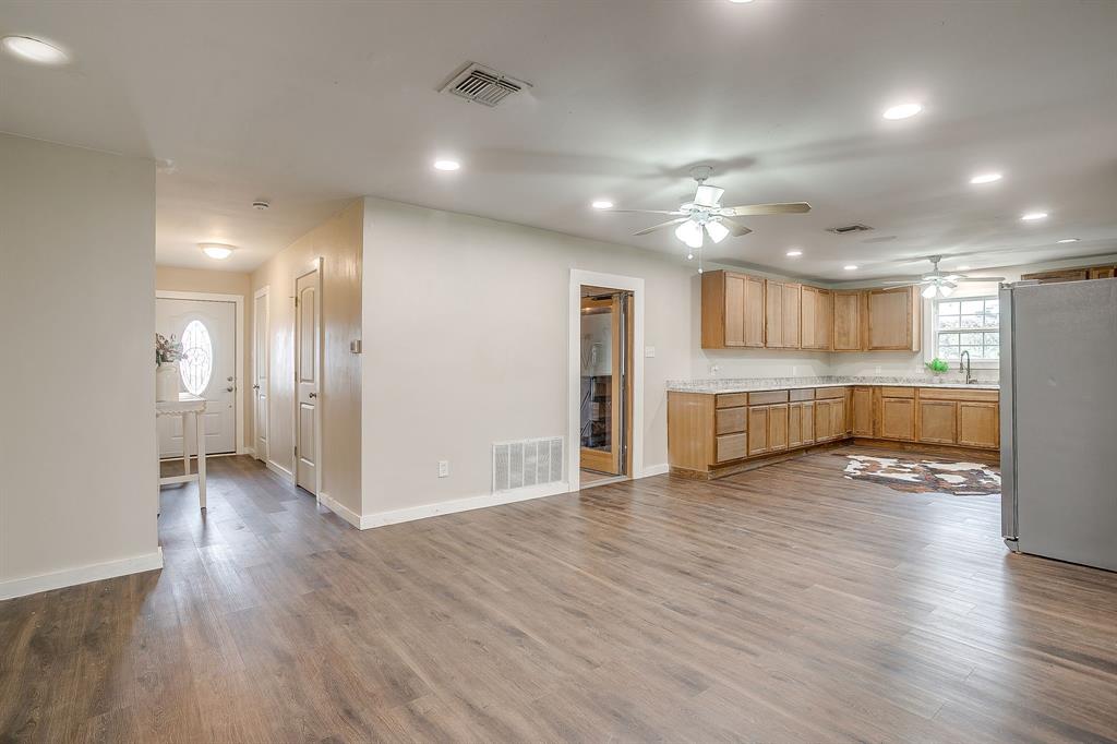6260 Silver Creek Azle Road Azle, TX 76020 - Photo 10 of 40 a view of an empty room and kitchen with wooden floor
