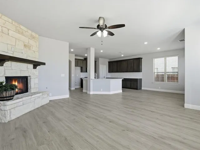 a view of a kitchen with a microwave and a fireplace
