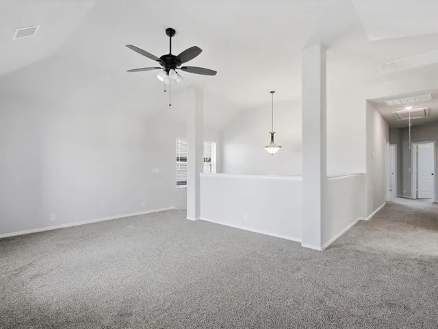 a view of a hallway with a ceiling fan