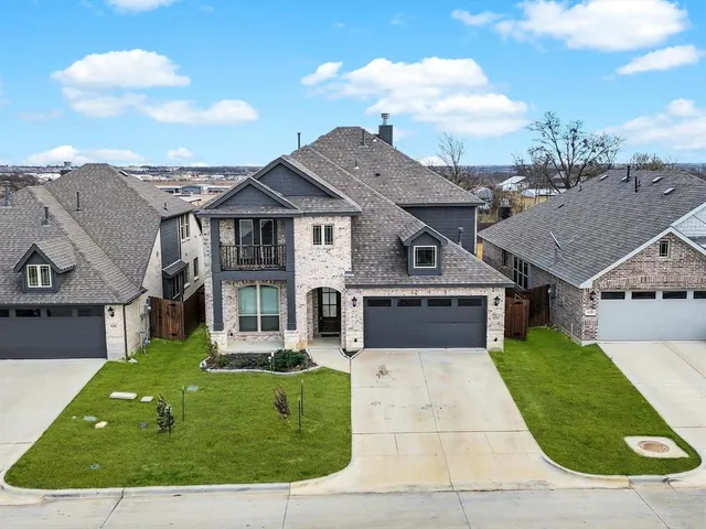 an aerial view of a house with a yard