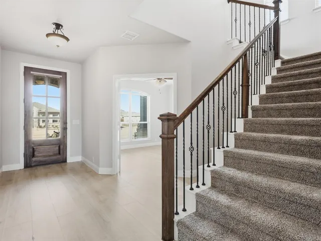 a view of an entryway with wooden floor and windows