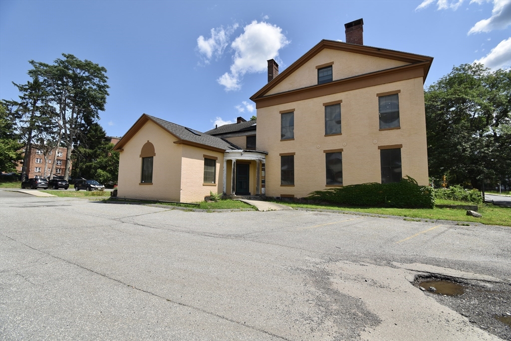 77 Maple Street Springfield, MA 01105 - Photo 1 of 18 a front view of a house with a yard and garage