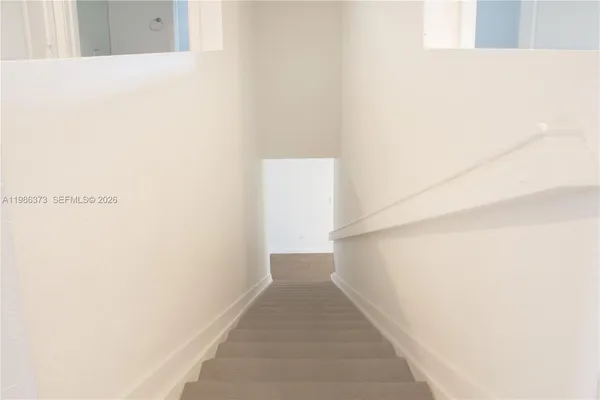 a view of empty room with white walls