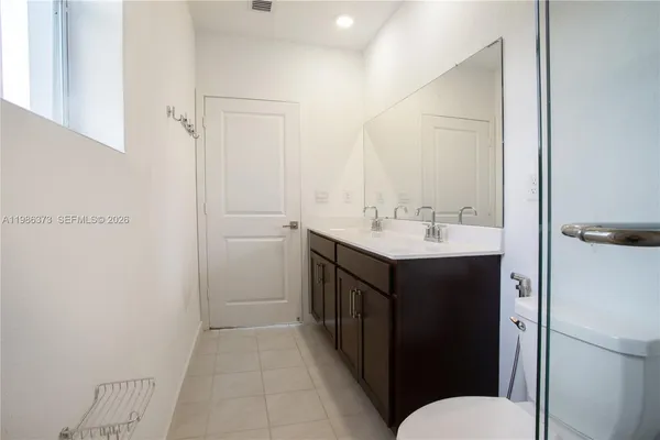 a kitchen with stainless steel appliances granite countertop a stove top oven a sink and white cabinets