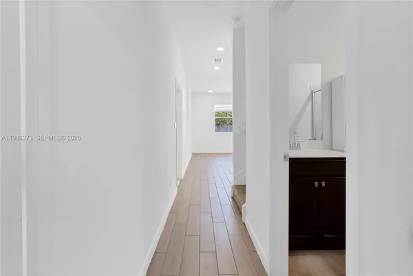 a kitchen with a sink and stainless steel appliances