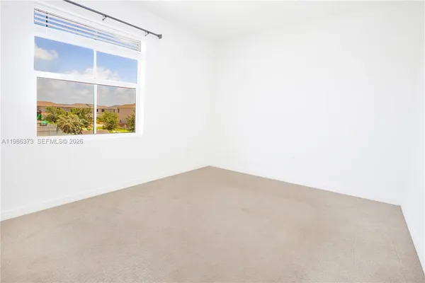 a kitchen with stainless steel appliances granite countertop a refrigerator a stove a sink and dishwasher with wooden floor