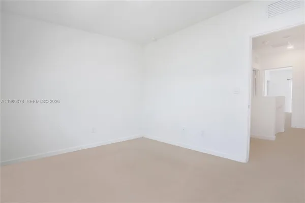 a view of a hallway with stairs