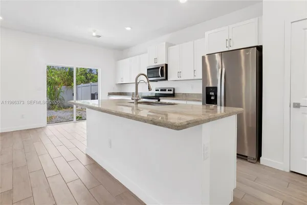 a view of a kitchen with a sink and a stove top oven