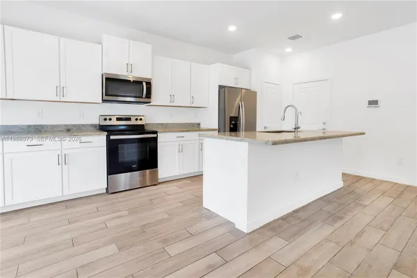 a kitchen with sink cabinets and window