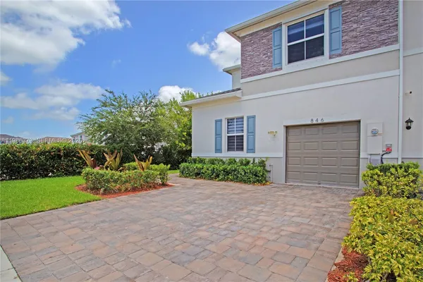 an outdoor space with pool and furniture