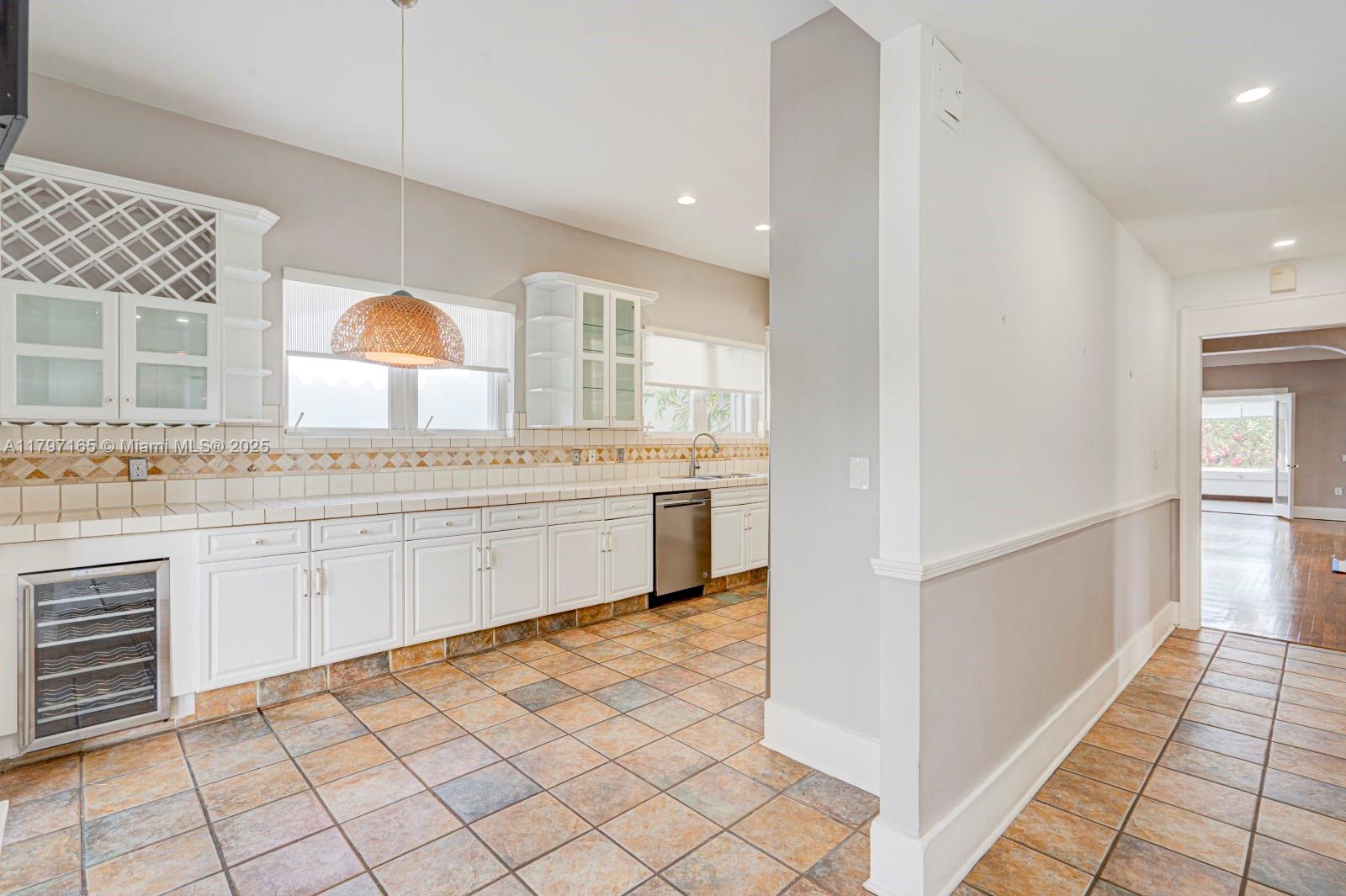 428 Southwest 23rd Road Miami, FL 33129 - Photo 11 of 36 a kitchen with granite countertop white cabinets and white appliances