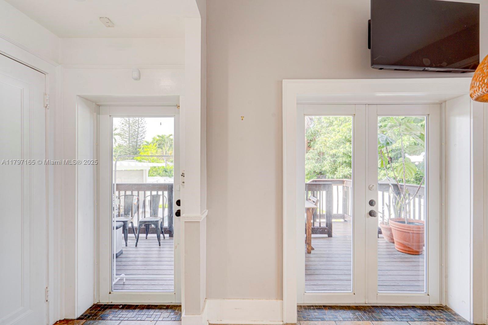 428 Southwest 23rd Road Miami, FL 33129 - Photo 13 of 36 a view of front door with wooden floor and chair