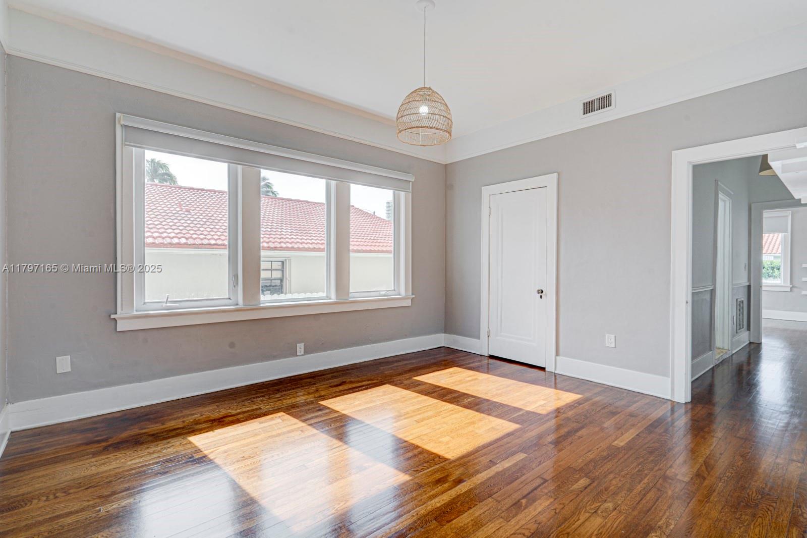 428 Southwest 23rd Road Miami, FL 33129 - Photo 16 of 36 a view of a room with wooden floor and window