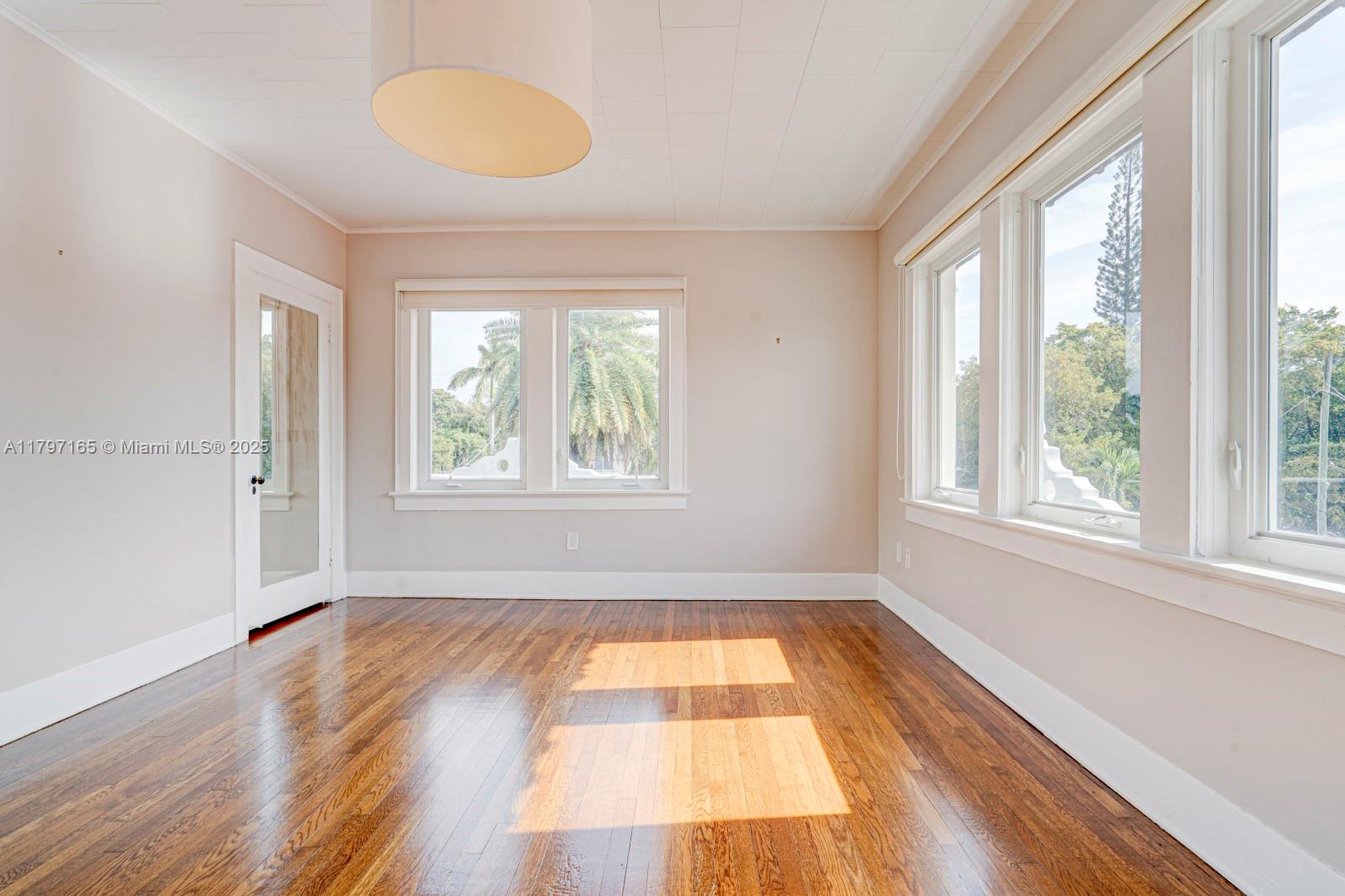 428 Southwest 23rd Road Miami, FL 33129 - Photo 17 of 36 an empty room with wooden floor and windows