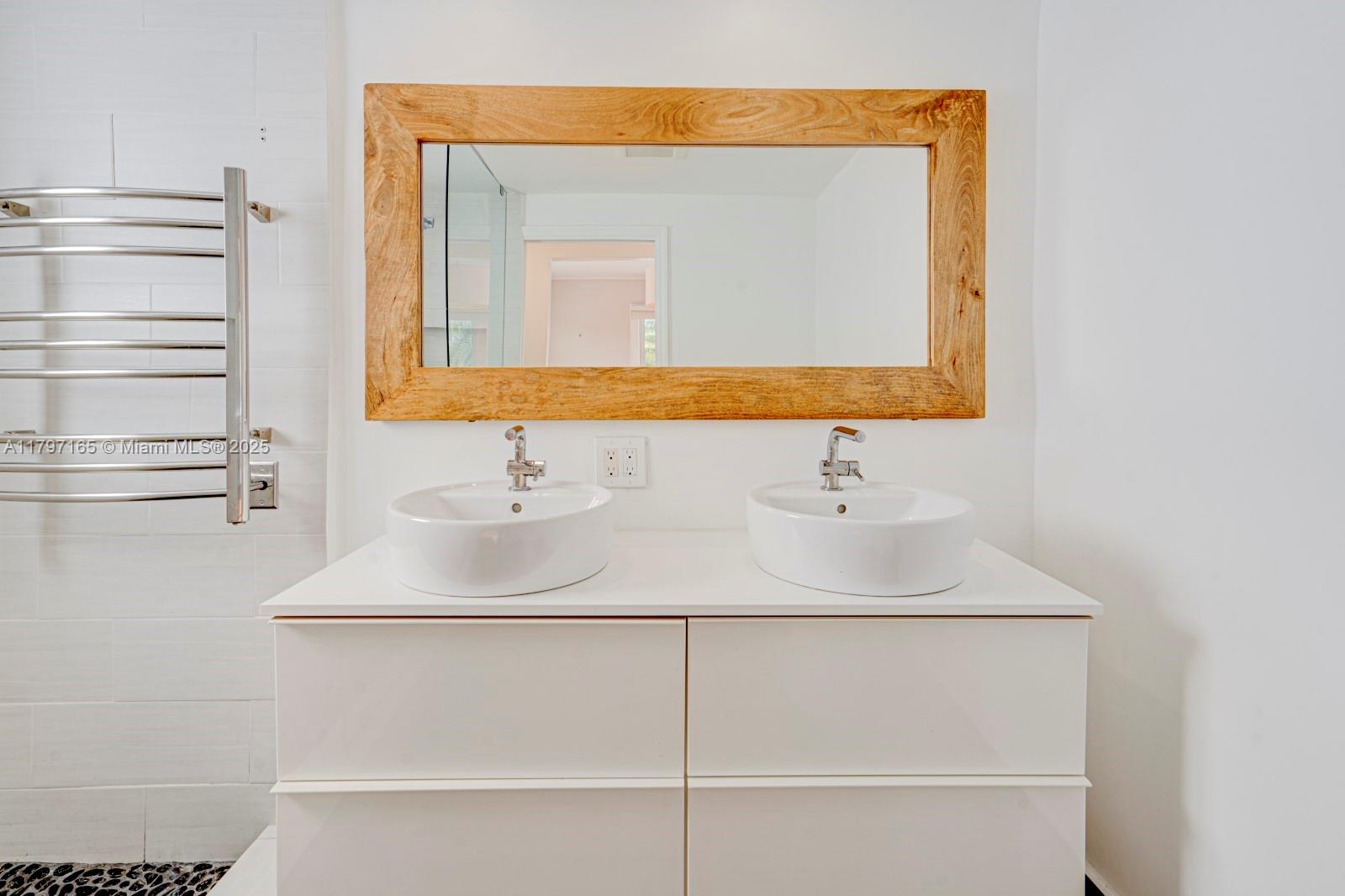 428 Southwest 23rd Road Miami, FL 33129 - Photo 20 of 36 a bathroom with a sink vanity and a mirror