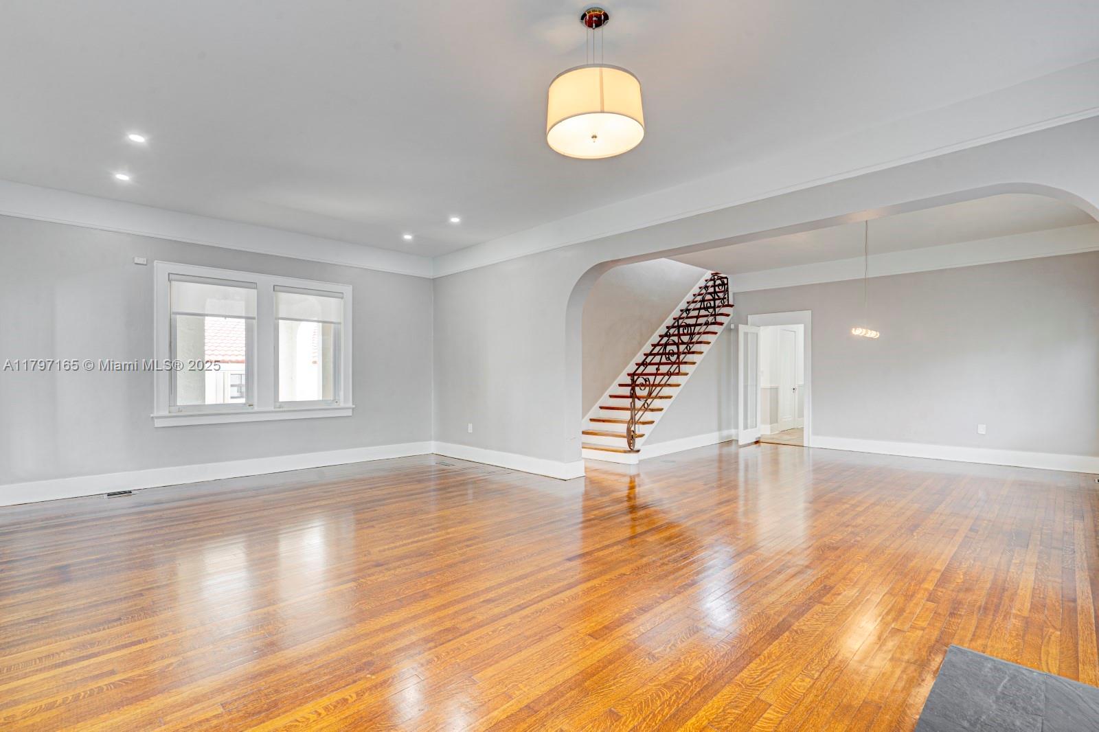 428 Southwest 23rd Road Miami, FL 33129 - Photo 2 of 36 a view of an empty room with wooden floor and window