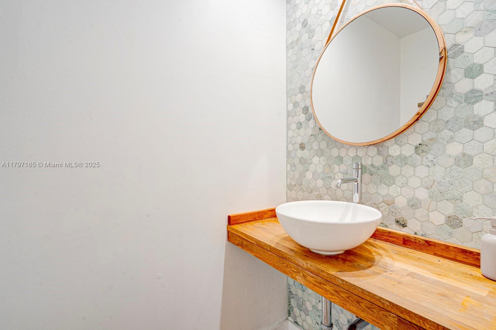 428 Southwest 23rd Road Miami, FL 33129 - Photo 24 of 36 a bathroom with a granite countertop sink and a mirror