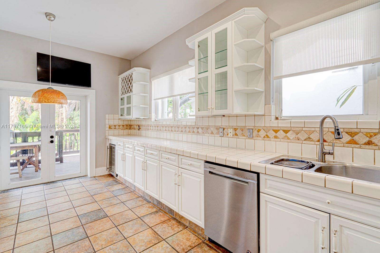 428 Southwest 23rd Road Miami, FL 33129 - Photo 8 of 36 a kitchen with stainless steel appliances granite countertop a sink and a stove