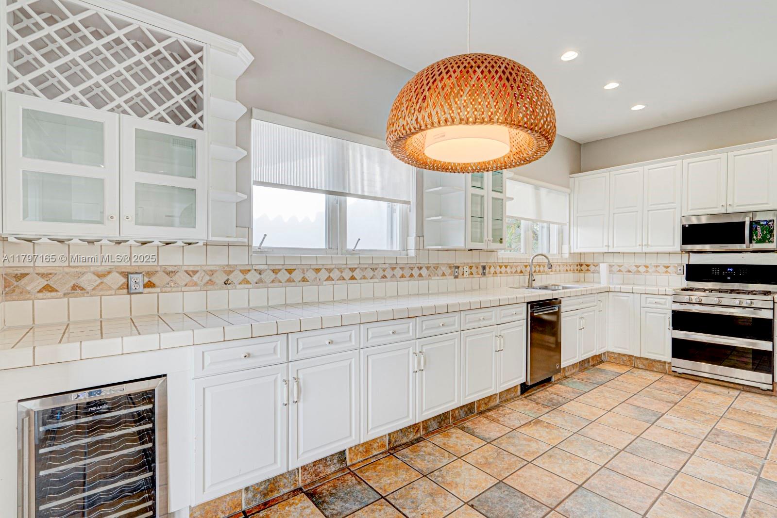 428 Southwest 23rd Road Miami, FL 33129 - Photo 9 of 36 a kitchen with a sink cabinets and appliances