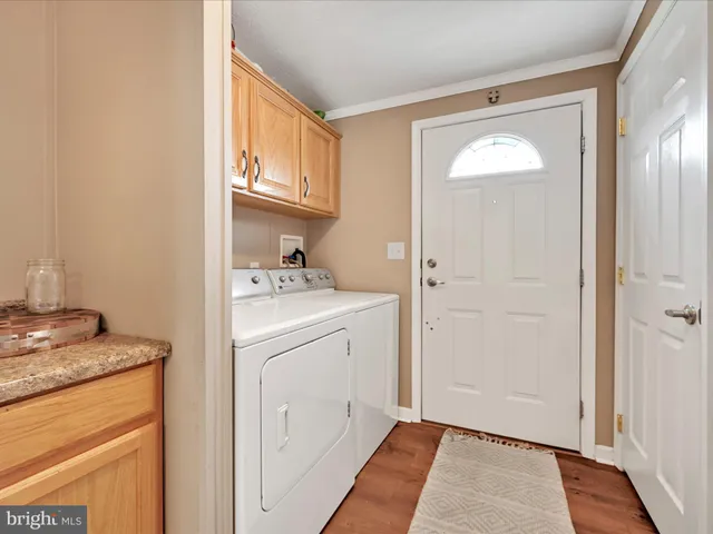 a utility room with cabinets washer and dryer