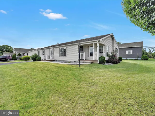 a view of house with yard and porch