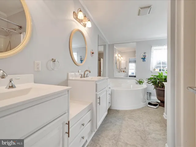 a spacious bathroom with a double vanity sink mirror and a