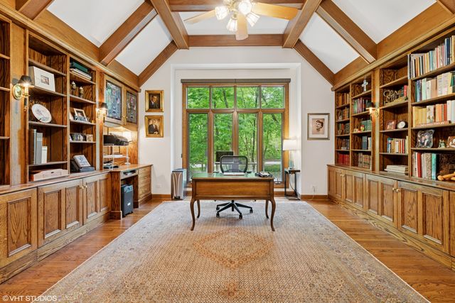 a living room with large couches and a book shelf