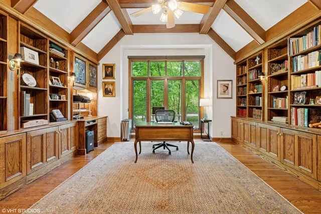 a living room with large couches and a book shelf