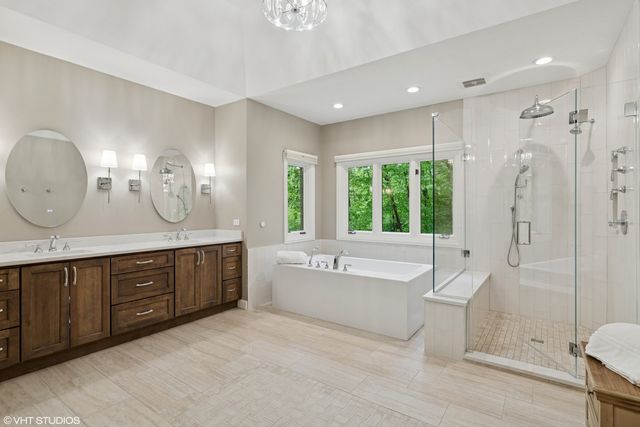 a spacious bathroom with a large tub shower and sink
