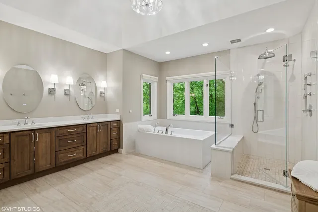 a spacious bathroom with a large tub shower and sink