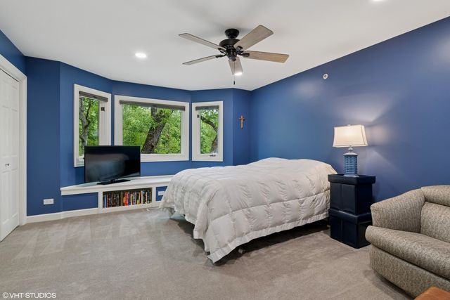 a bed room with a bed and a chair