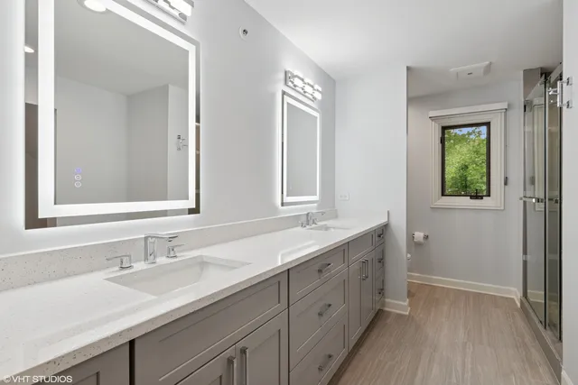 a bathroom with 2 sink tub and a mirror