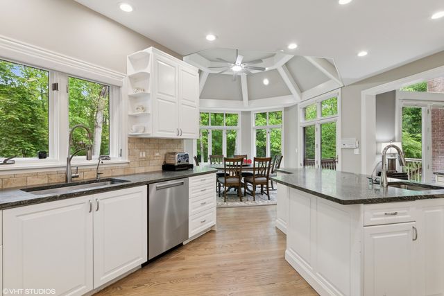 a kitchen with sink cabinets and window