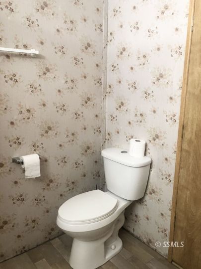 3713 Goat Ranch Road Mountain Mesa, CA 93240 - Photo 9 of 43 a bathroom with a toilet and a sink