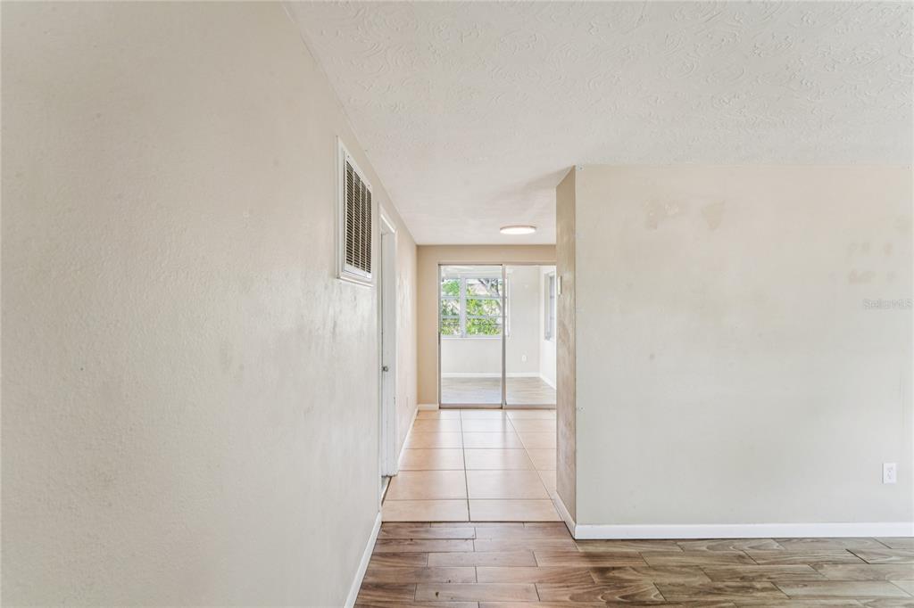 4837 Vision Avenue Holiday, FL 34690 - Photo 11 of 38 a view of a hallway with wooden floor and a window