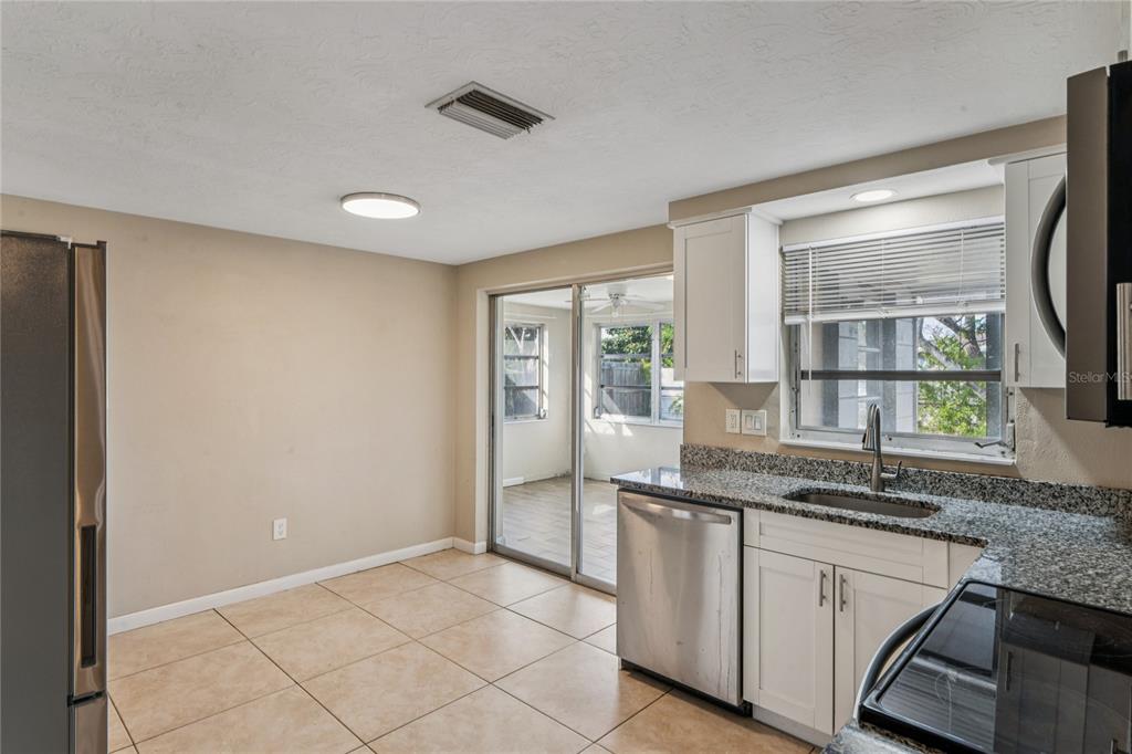 4837 Vision Avenue Holiday, FL 34690 - Photo 17 of 38 a kitchen with granite countertop a sink and a stove