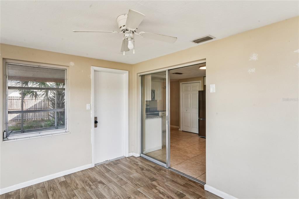 4837 Vision Avenue Holiday, FL 34690 - Photo 19 of 38 a view of an empty room with wooden floor and a window