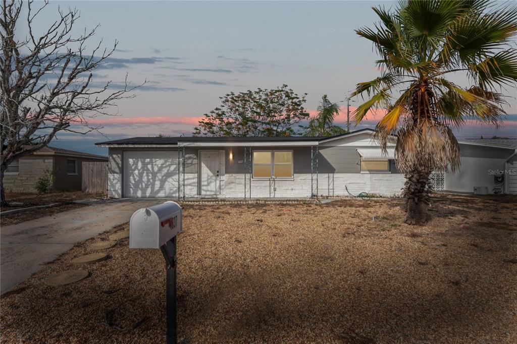 4837 Vision Avenue Holiday, FL 34690 - Photo 2 of 38 a front view of a house with a yard and garage