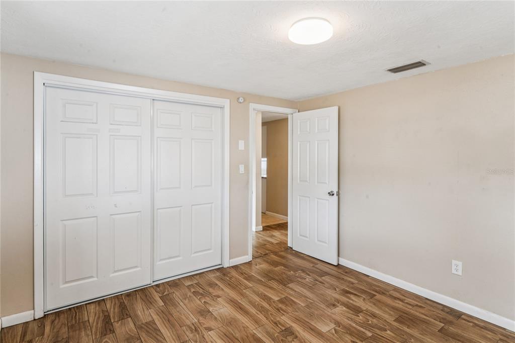 4837 Vision Avenue Holiday, FL 34690 - Photo 21 of 38 wooden floor in an empty room