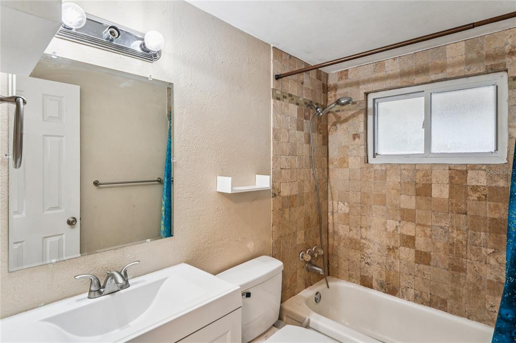 4837 Vision Avenue Holiday, FL 34690 - Photo 23 of 38 a bathroom with a sink toilet and shower