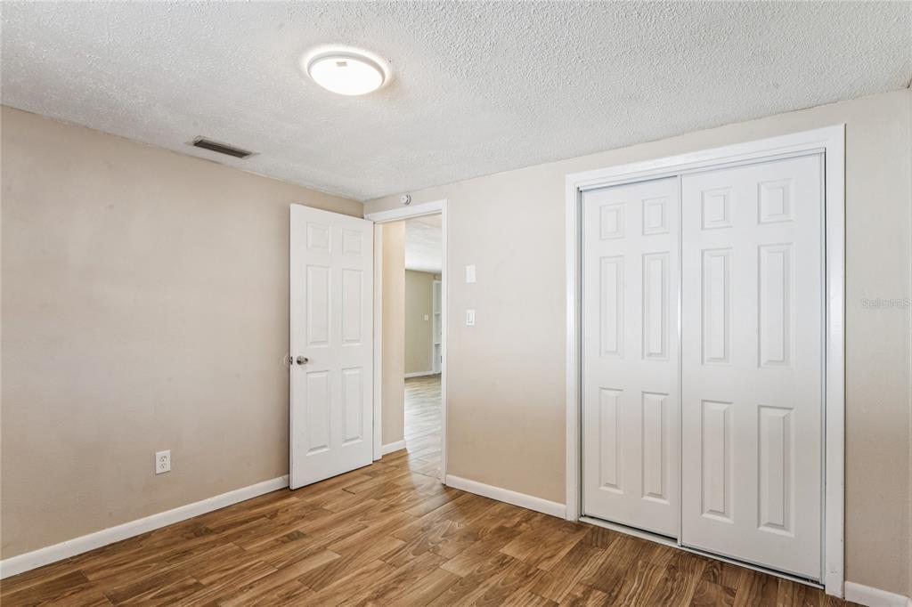 4837 Vision Avenue Holiday, FL 34690 - Photo 26 of 38 a view of an empty room with wooden floor