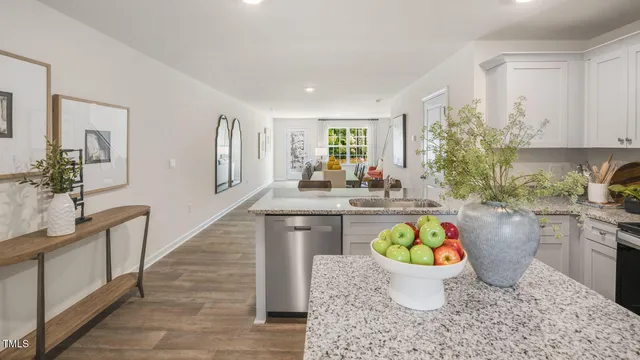 a room with wooden floor and white walls