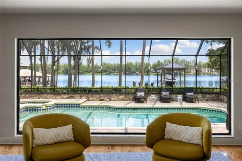 a living room with a couch and a floor to ceiling window
