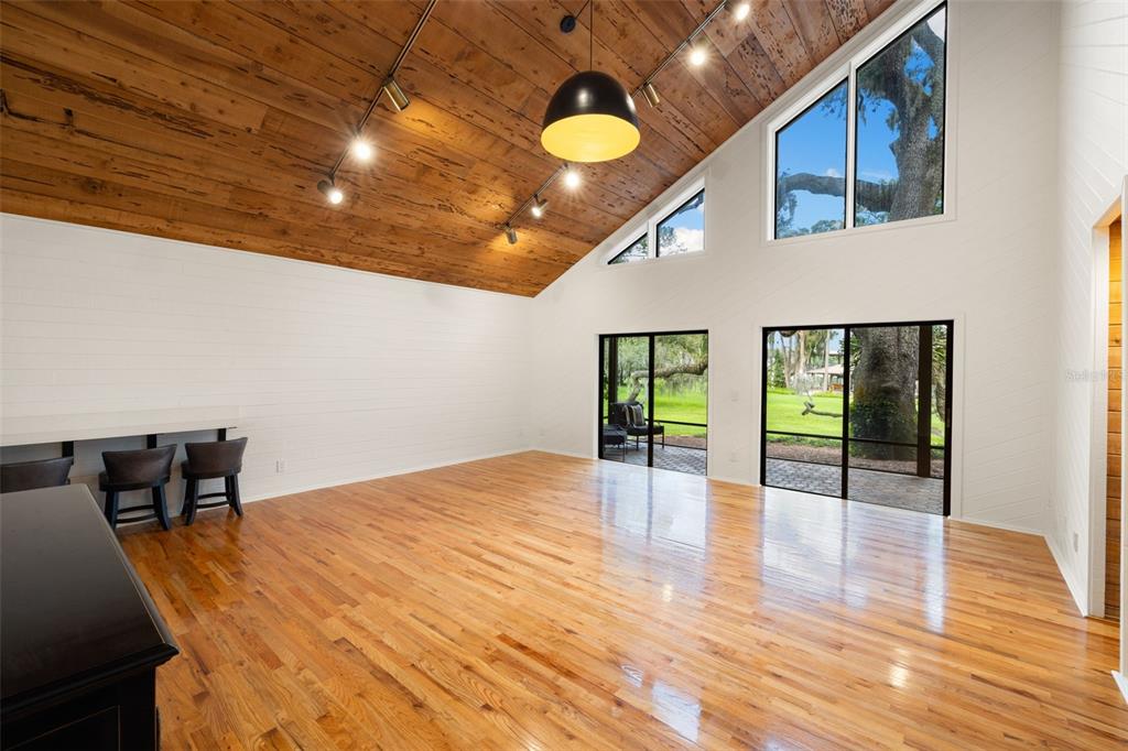 9116 Roberts Road Odessa, FL 33556 - Photo 14 of 94 a view of an empty room with window and wooden floor