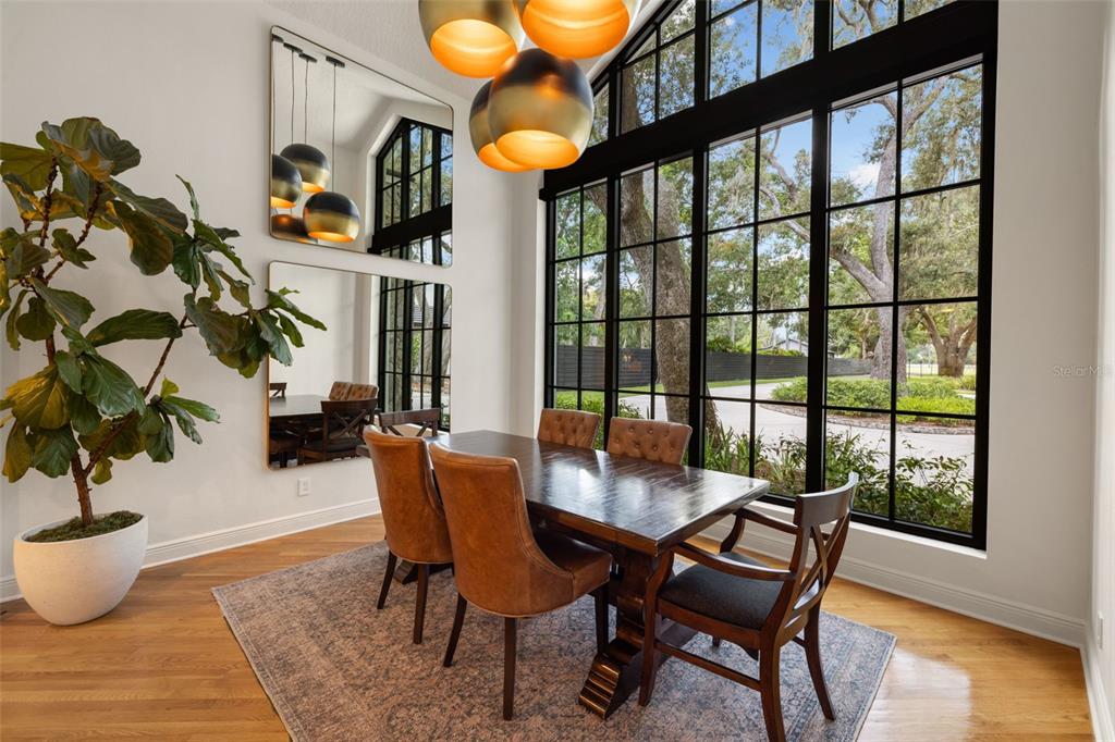 9116 Roberts Road Odessa, FL 33556 - Photo 21 of 94 a dining room with furniture and wooden floor