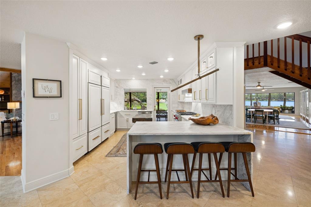 9116 Roberts Road Odessa, FL 33556 - Photo 25 of 94 a view of a dining room and livingroom with furniture wooden floor a chandelier