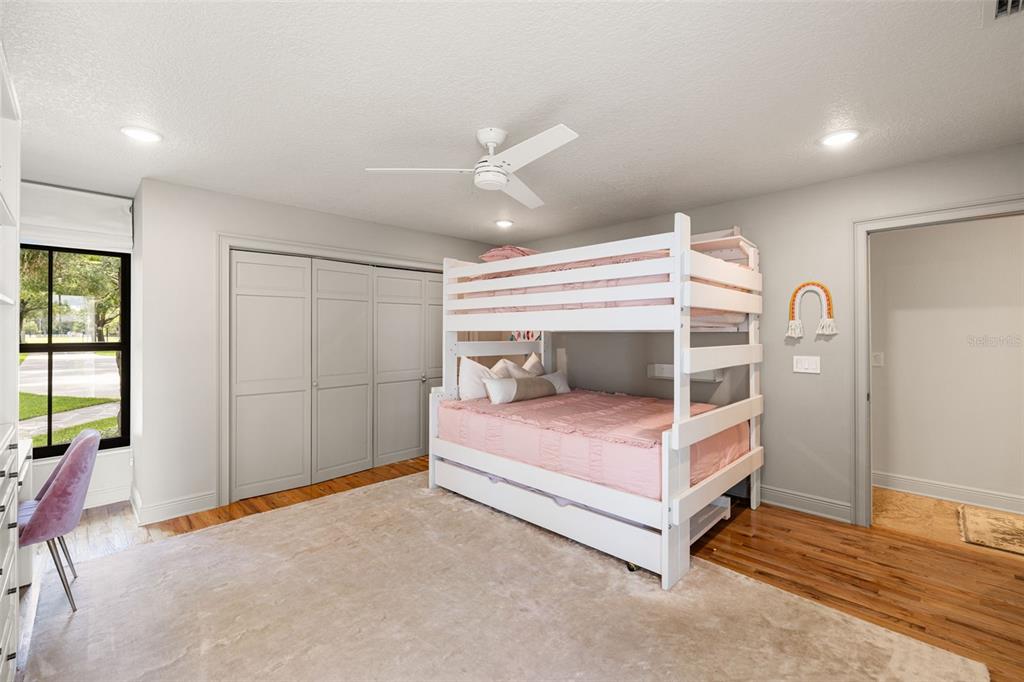 9116 Roberts Road Odessa, FL 33556 - Photo 46 of 94 a bedroom with a bed and a chandelier