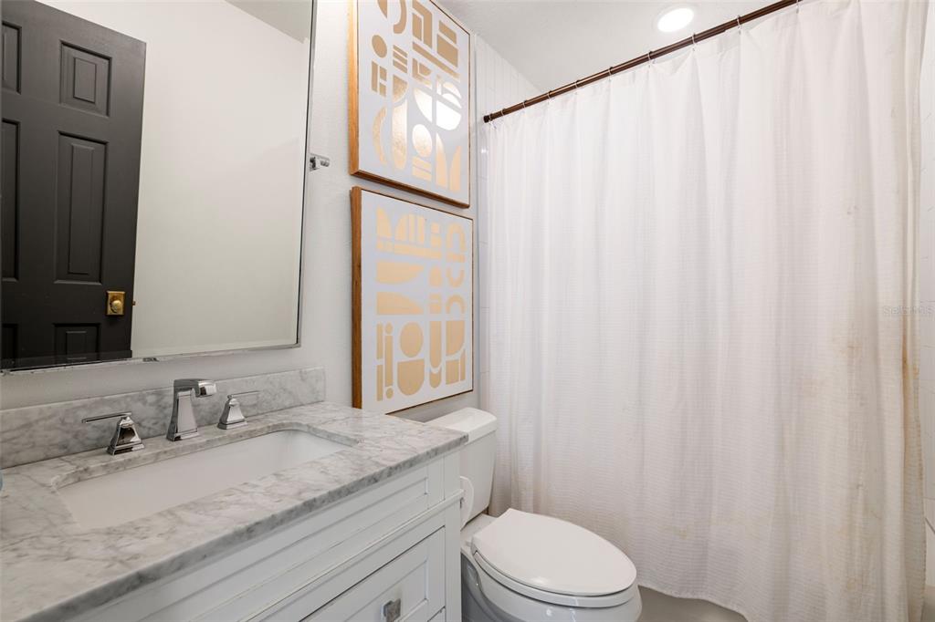 9116 Roberts Road Odessa, FL 33556 - Photo 48 of 94 a bathroom with a granite countertop sink and a mirror