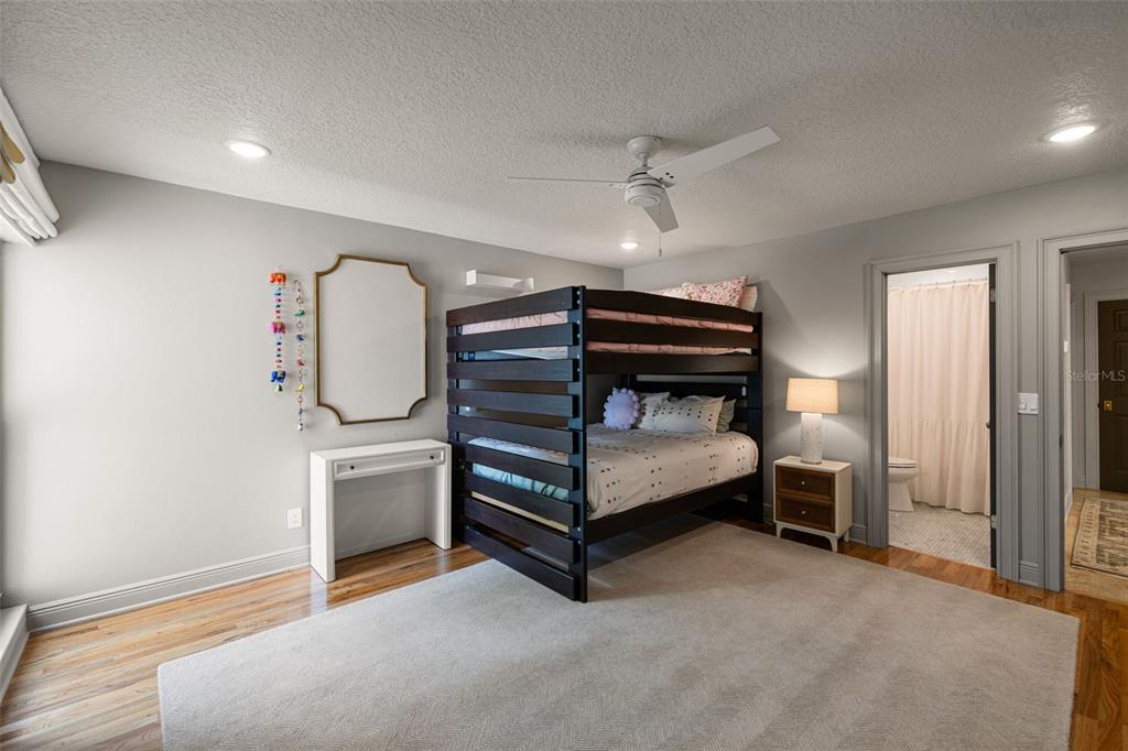 9116 Roberts Road Odessa, FL 33556 - Photo 49 of 94 a bedroom with furniture and a chandelier