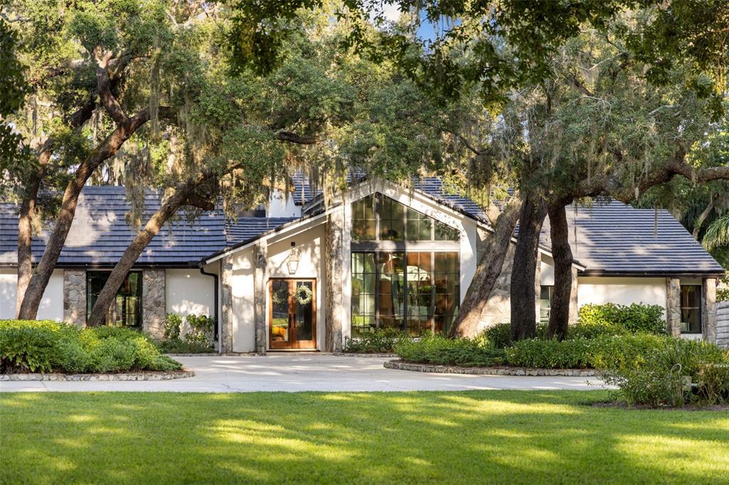 9116 Roberts Road Odessa, FL 33556 - Photo 8 of 94 a front view of a house with a yard and palm trees
